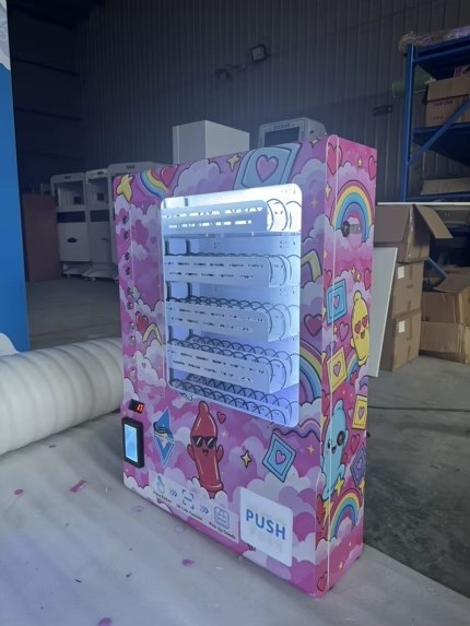 Photograph of a colorful sexual-wellness vending machine prototype in a workshop